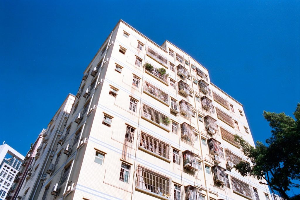 Expert Home and Office Renovation Services Tall apartment building against a clear blue sky