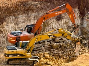The Quarry Investor’s Challenge: Two excavators digging a construction site